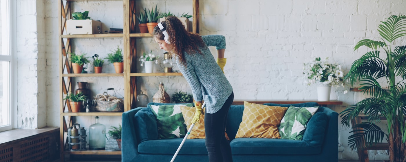 Cleaning professional mopping a bright, freshly tidied living space
