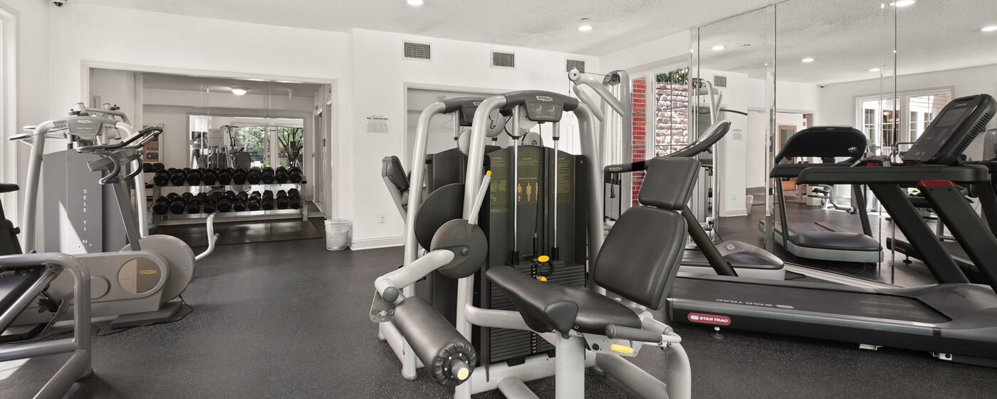 Gym floor with treadmills, weight machines and free weights