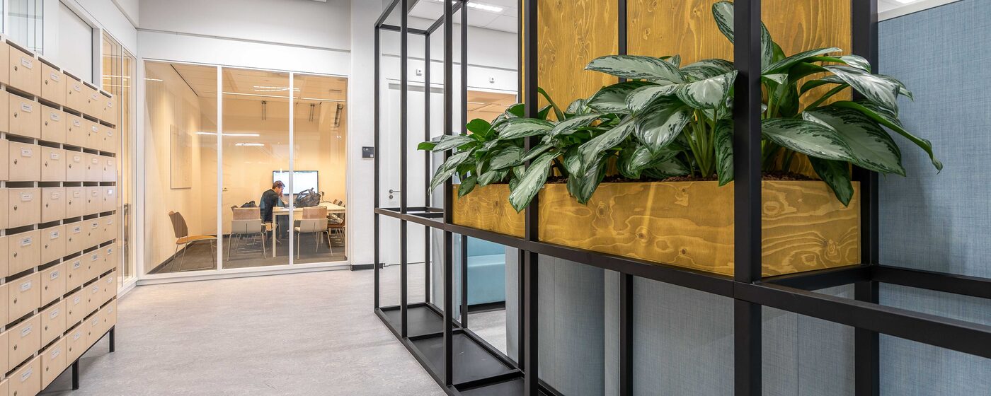 Small private office suite with a glass-walled meeting room off the corridor